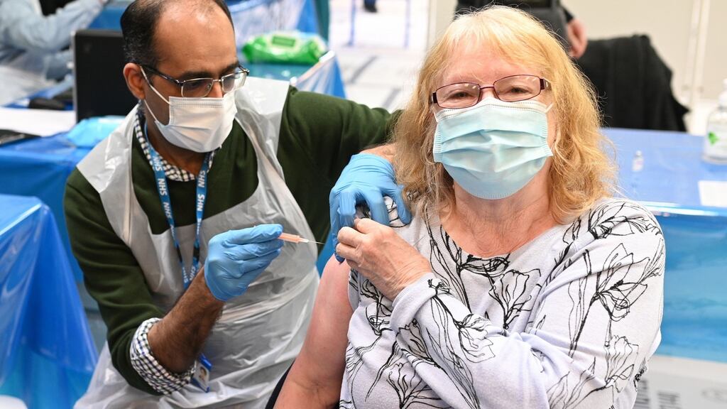 Pharmacist Murtaza Abdulkarim (L) administers a dose of the AstraZeneca vaccine at a temporary vaccination centre, staffed by pharmacists and pharmacist assistants, in Birmingham, England on Thursday. Photograph: Oli Scarff/AFP via Getty Images