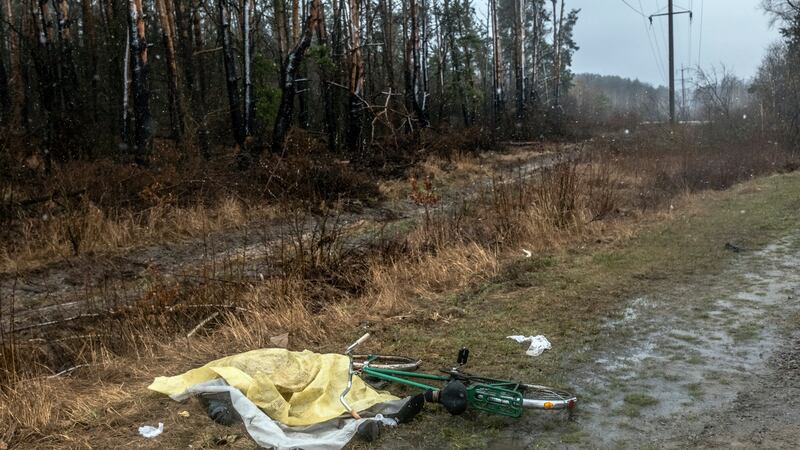 The body of a man with a gunshot wound to his head near his bicycle just outside Bucha. Photograph: Daniel Berehulak/New York Times