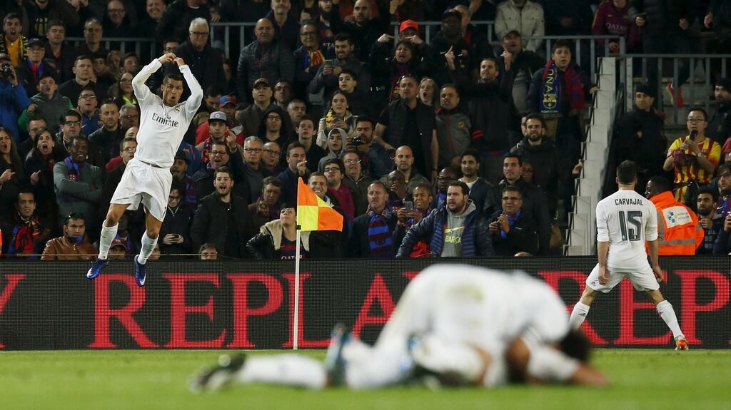 Real Madrid’s Cristiano Ronaldo (l) celebrates his side’s second goal before a stunned Nou Camp crowd Photograph: Reuters/Albert Gea