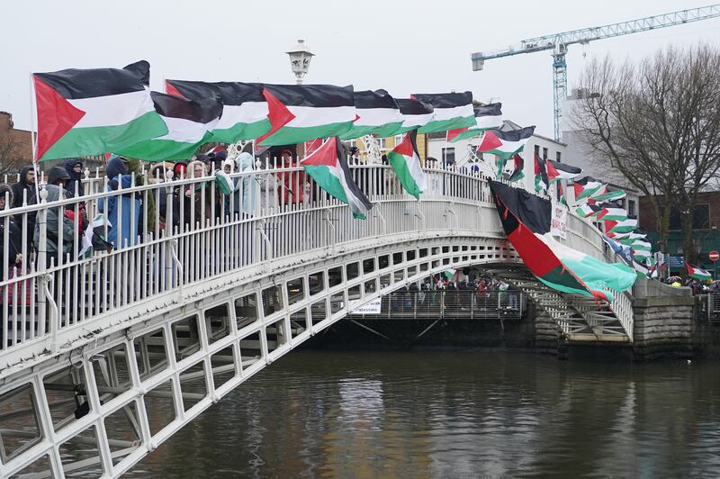 Protesters display Palestinian flags on Dublin's Ha'penny Bridge. Photograph: Niall Carson/PA Wire