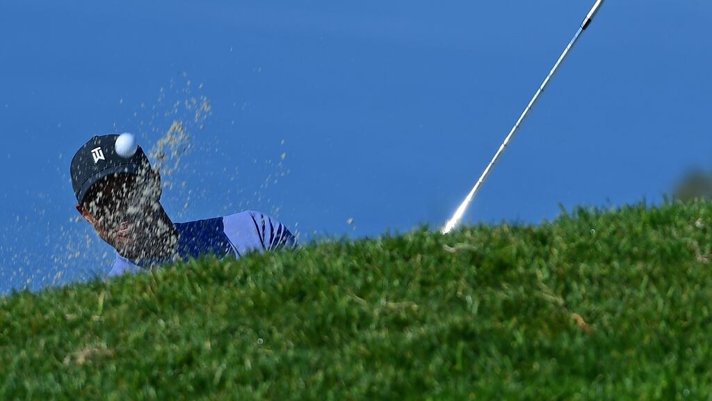 Tiger Woods plays a shot from a bunker on the 11th hole during the first round of the Farmers Insurance Open at Torrey Pines. Photo: Donald Miralle/Getty Images