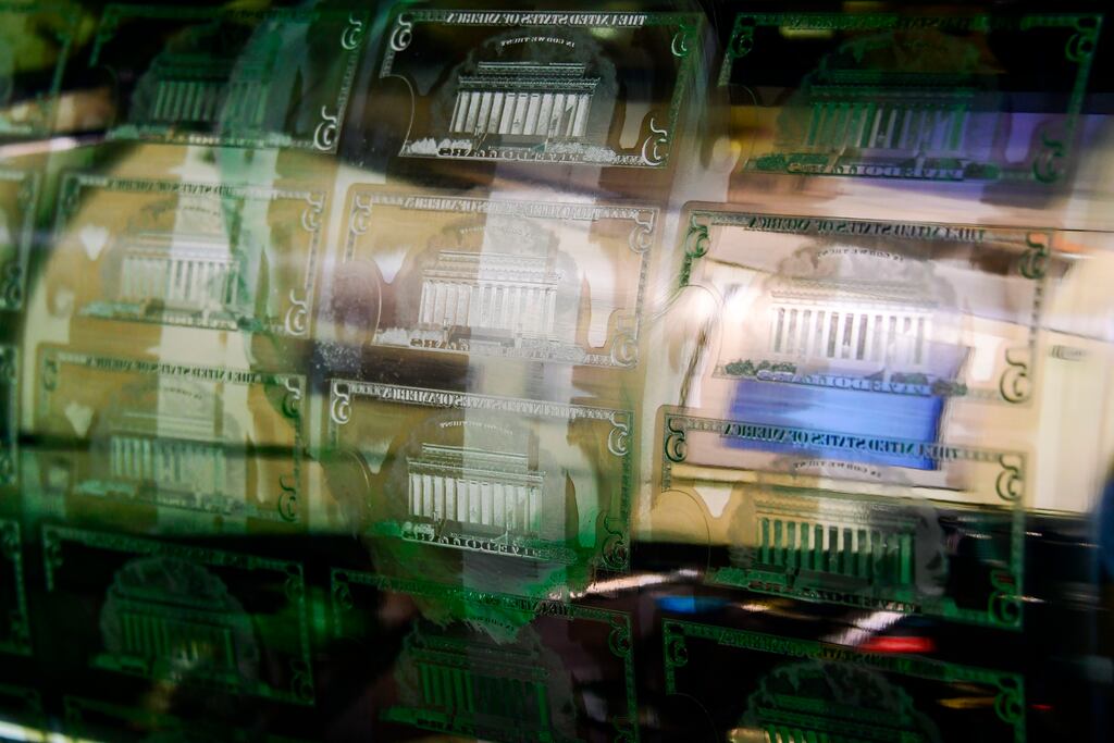An inked printing plate for a sheet of $5 notes on a press at the US treasury's bureau of engraving and printing in Washington, DC