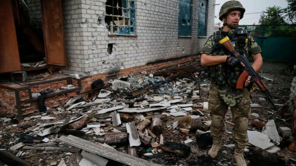 A member of Ukrainian police special task force Kiev-1 patrols in the eastern Ukrainian village of Semenovka, near Sloviansk, today. Photograph: Gleb Garanich/Reuters