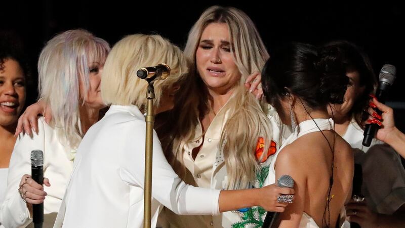 Kesha (C) is embraced by a multitude of singers after they performed ‘Praying’’ Photograph: Lucas Jackson/Reuters