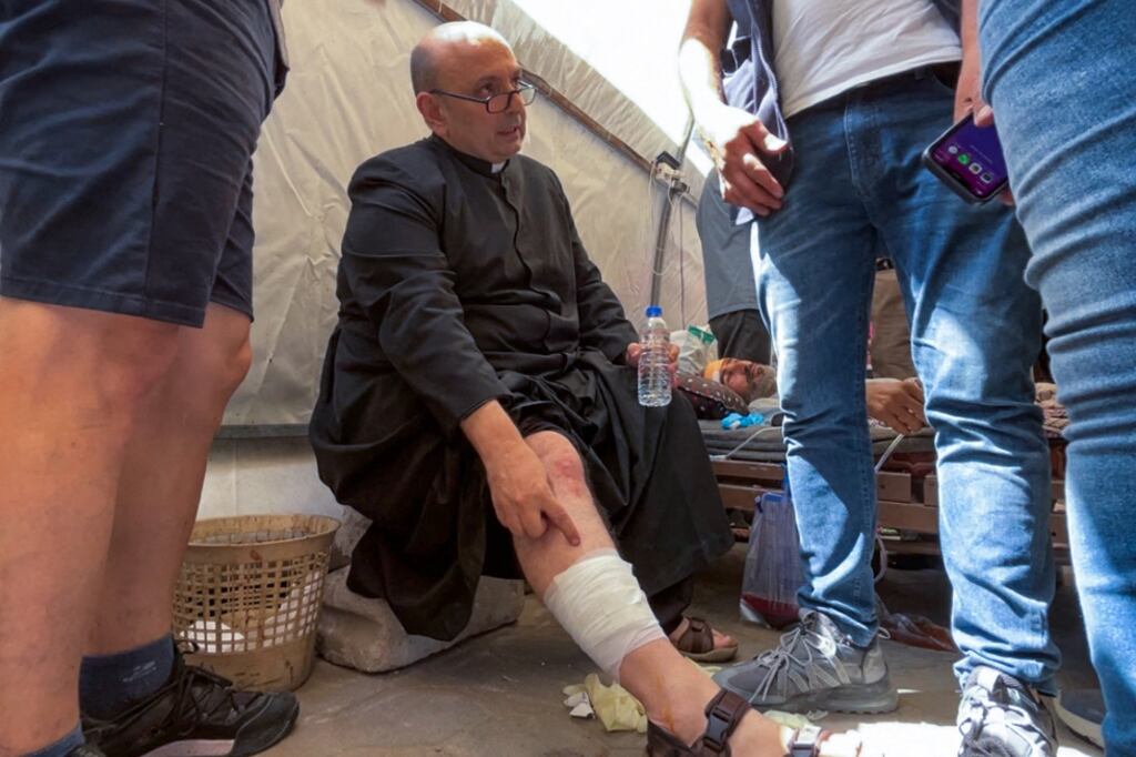 Fr Gabriel Romanelli, parish priest of the Holy Family church in Gaza City, receives treatment at the al-Ahli Arab hospital on Thursday. Photograph: Omar al-Qattaa/AFP via Getty Images