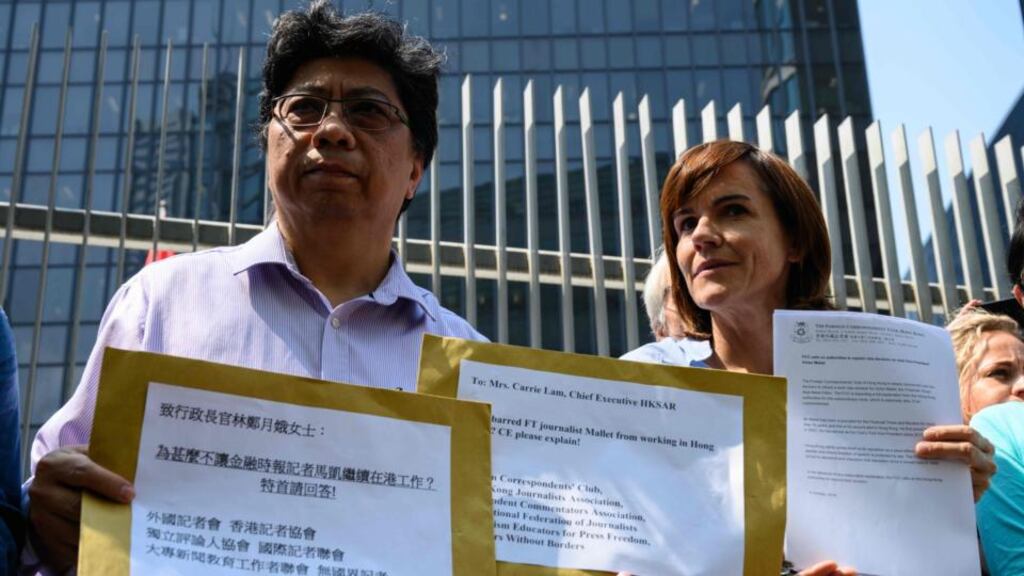 Chris Yeung, chairman of the Hong Kong Journalist Association, with Foreign Correspondents’ Club president Florence de Changy outside government headquarters in Hong Kong on Monday. They handed over petitions calling for an explanation of its visa rejection of Financial Times journalist Victor Mallet. Photograph: Anthony Wallace/AFP/Getty Images