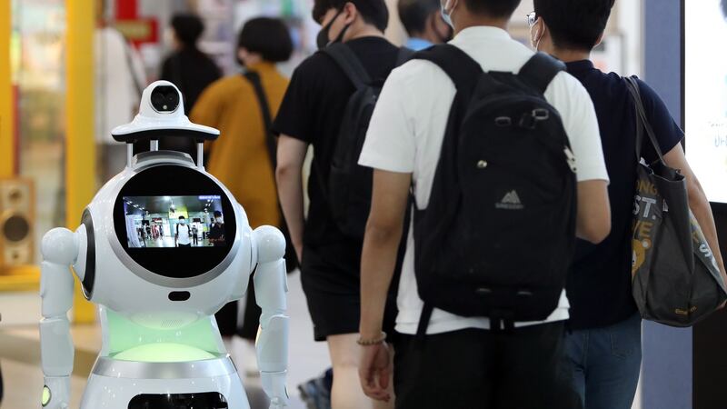 A robot checks the body temperature of passengers at a bus terminal in Gwangju, South Korea. Photograph: EPA/Yonhap