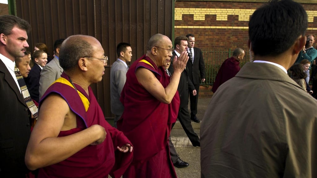 The Dalai Lama crosses the peace line at Workman Avenue and Springfield Road in Belfast in October 2000. Photograph: Dara Mac Dónaill