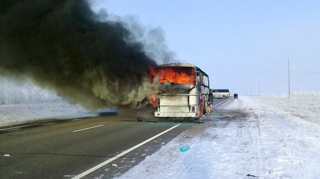 A bus burns on a road  near the village of Kalybai in Kazakhstan. Emergency officials say 52 people of 57 on the bus died on the fire. Photograph: Kazakhstan Ministry for Emergency Situations via AP