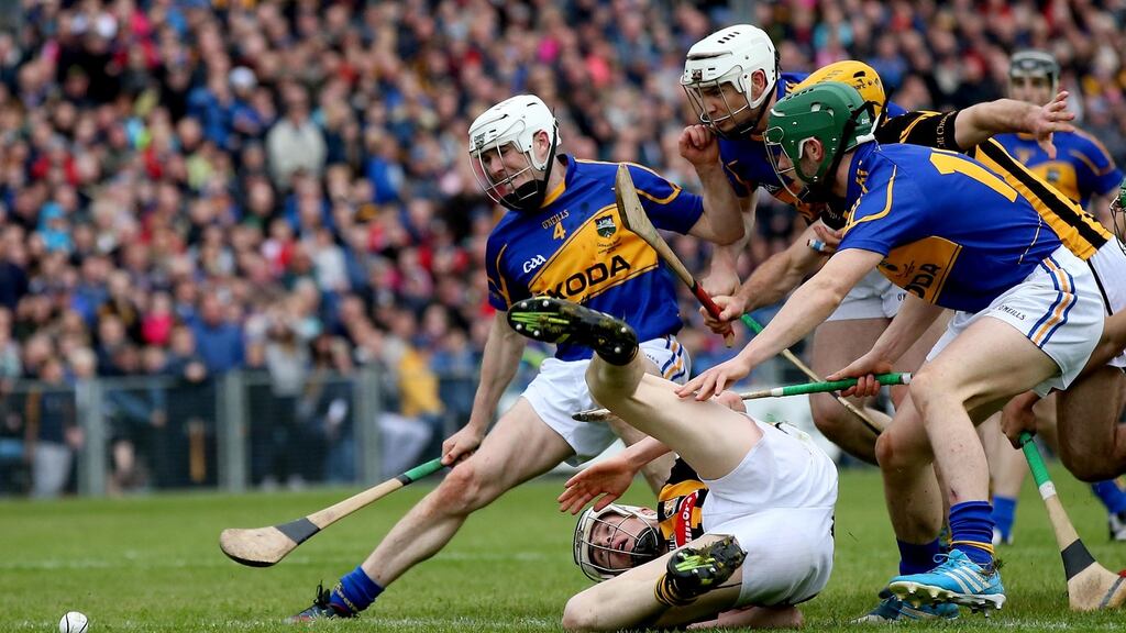 Kilkenny’s TJ Reid battles with Tipperary’s Michael Cahill, Brendan Maher and Cathal Barrett during the 2014 league final. Photo graph: James Crombie/Inpho