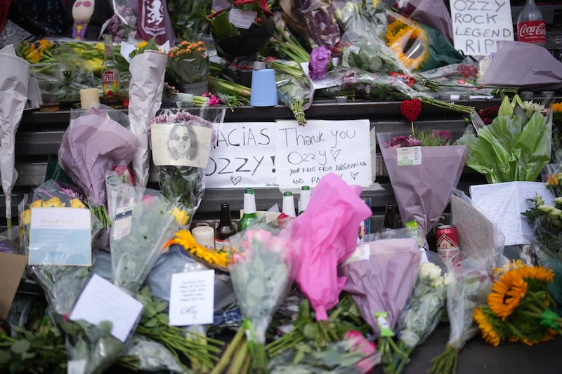 Tributes to Ozzy Osbourne on the Black Sabbath Bridge bench in Birmingham, England. Photograph: Christopher Furlong/Getty Images