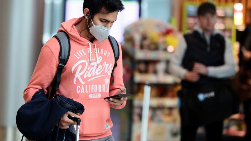 A man wearing a facemask in the arrivals hall of Terminal 2 at Dublin Airport on Friday.  Photograph: Brian Lawless/PA