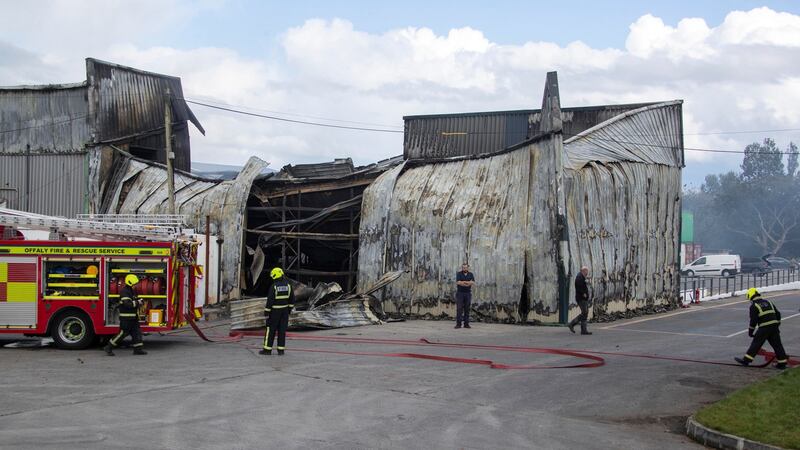 Firefighters at the Glenisk factory on Tuesday which was extensively damaged in a fire at the plant on Monday. Photograph: Collins