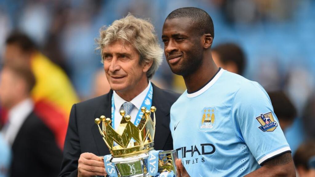 Manchester City manager Manuel Pellegrini and Yaya Toure pose with the Premier League trophy at the end of the season. Photograph: Getty Images