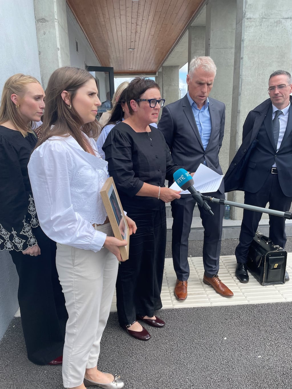 Maria Sheridan, mother of road crash victim Rian Sheridan, speaking outside Roscommon Circuit Criminal Court, surrounded by family, friends and family solicitor