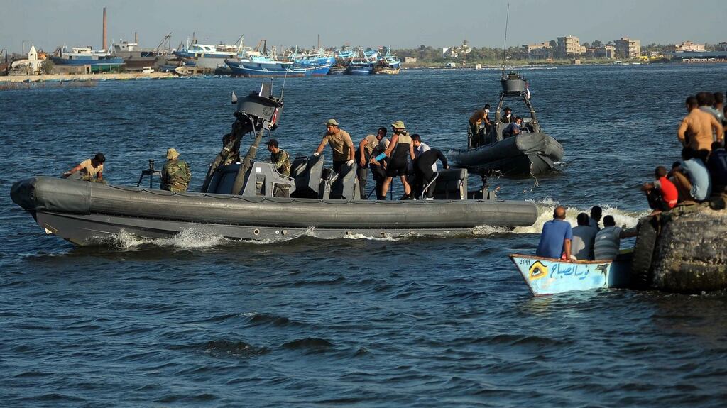 A vessel carrying recovered bodies placed in body bags arrives in the port city of Rosetta, 250km from Cairo. Photograph: EPA