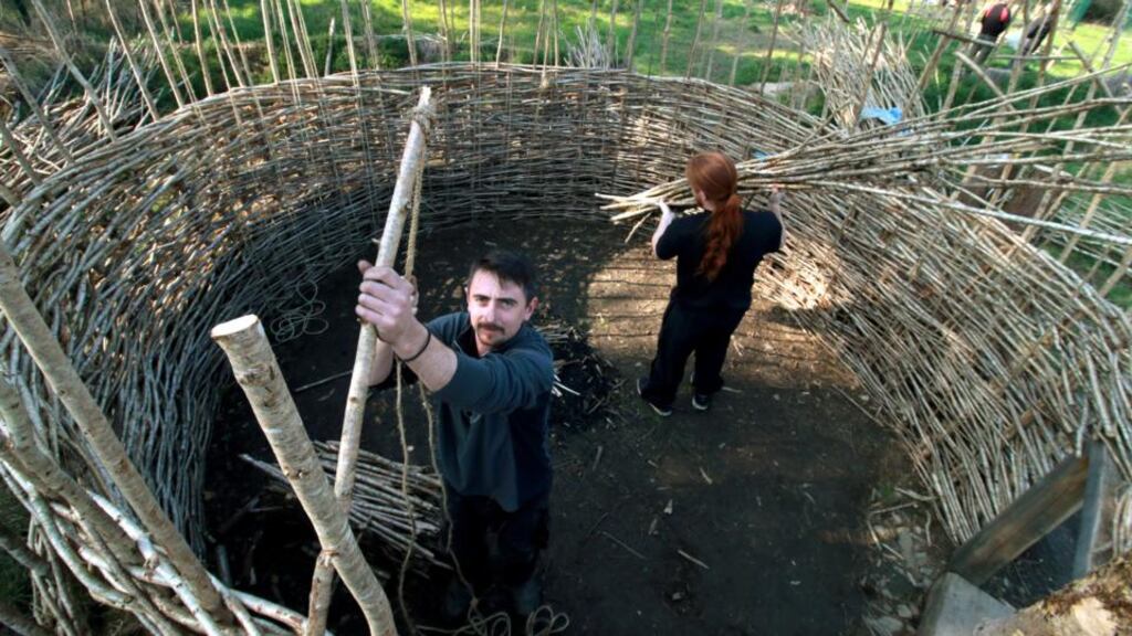 Brendan O’Neill  at work on his early medieval round house on the UCD campus. Photograph:  Nick Bradshaw