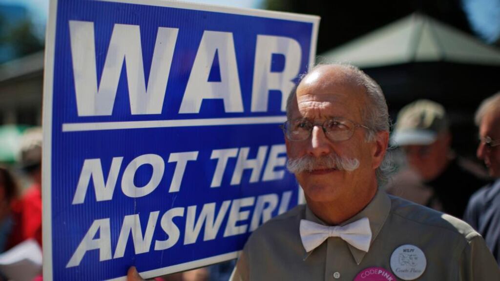 Andre Sheldon, from the group Global Strategy of Non-Violence, holds a sign during an anti-war rally in Boston, Massachusetts today. Photograph: Brian Snyder/Reuters