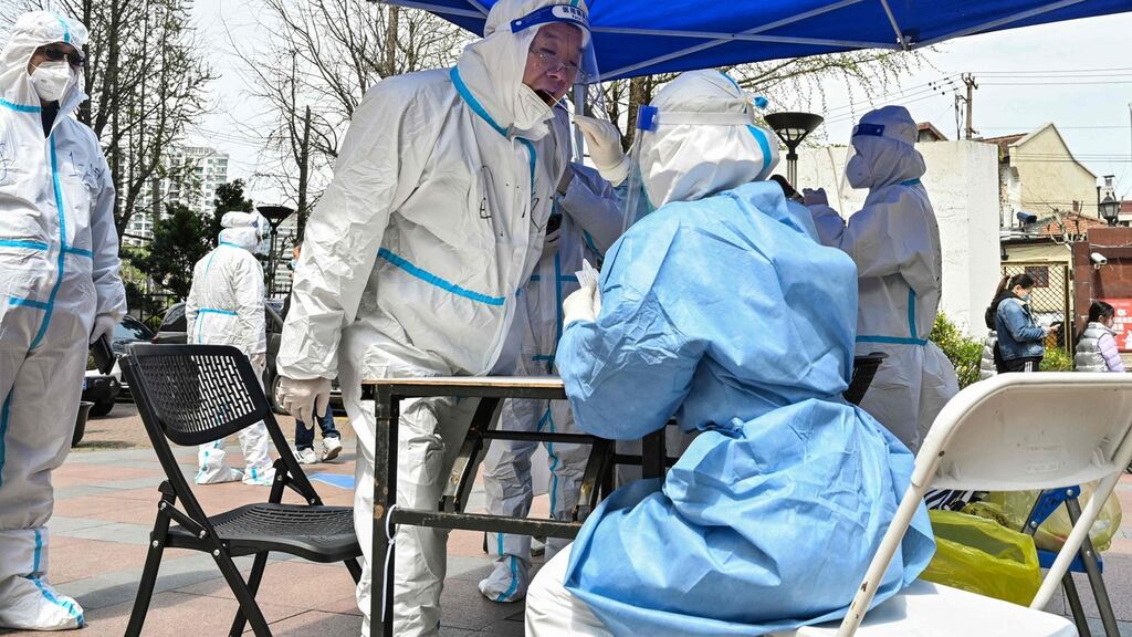 Health workers carry out Covid tests on residents in locked-down Shanghai. Photograph: Hector Retamal/AFP via Getty Images