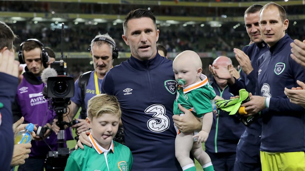 Robbie Keane and his sons Robert and Hudson are applauded off the pitch by team-mates at the end of the game. Photograph: Morgan Treacy/Inpho