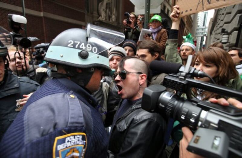 An Occupy Wall Street protester and New York police officer face off during during a march in Manhattan. Photograph: Chang W Lee/The New York Times