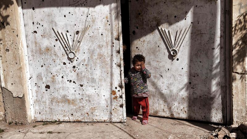 An Iraqi child in west Mosul as Iraqi forces struggle with Isis fighters for control of the area. Photograph: AFP/Getty Images