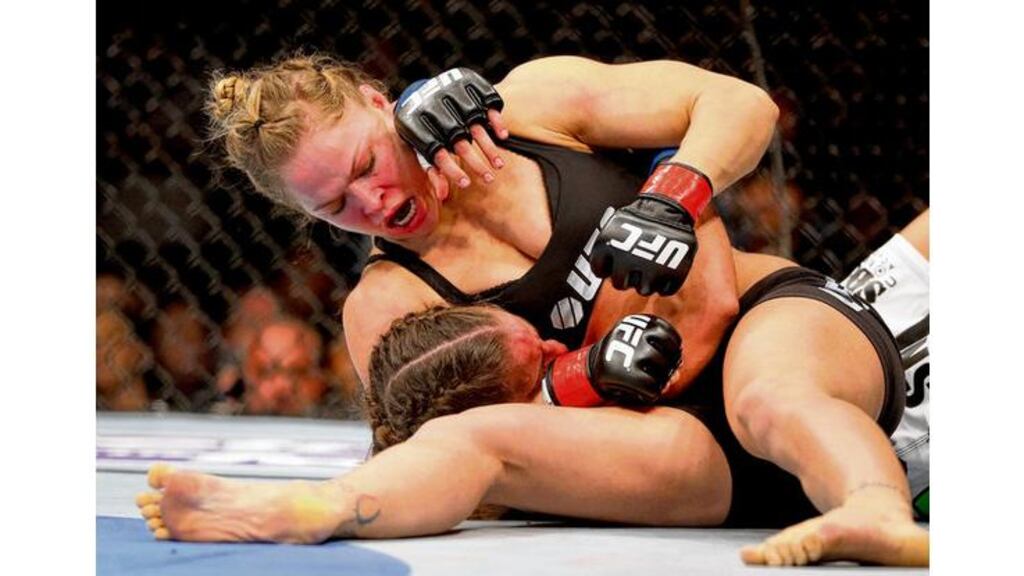 Ronda Rousey hits Liz Carmouche during their historic UFC Bantamweight Title fight at Honda Center in Anaheim, California last weekend. Photograph: Jeff Gross/Getty Images