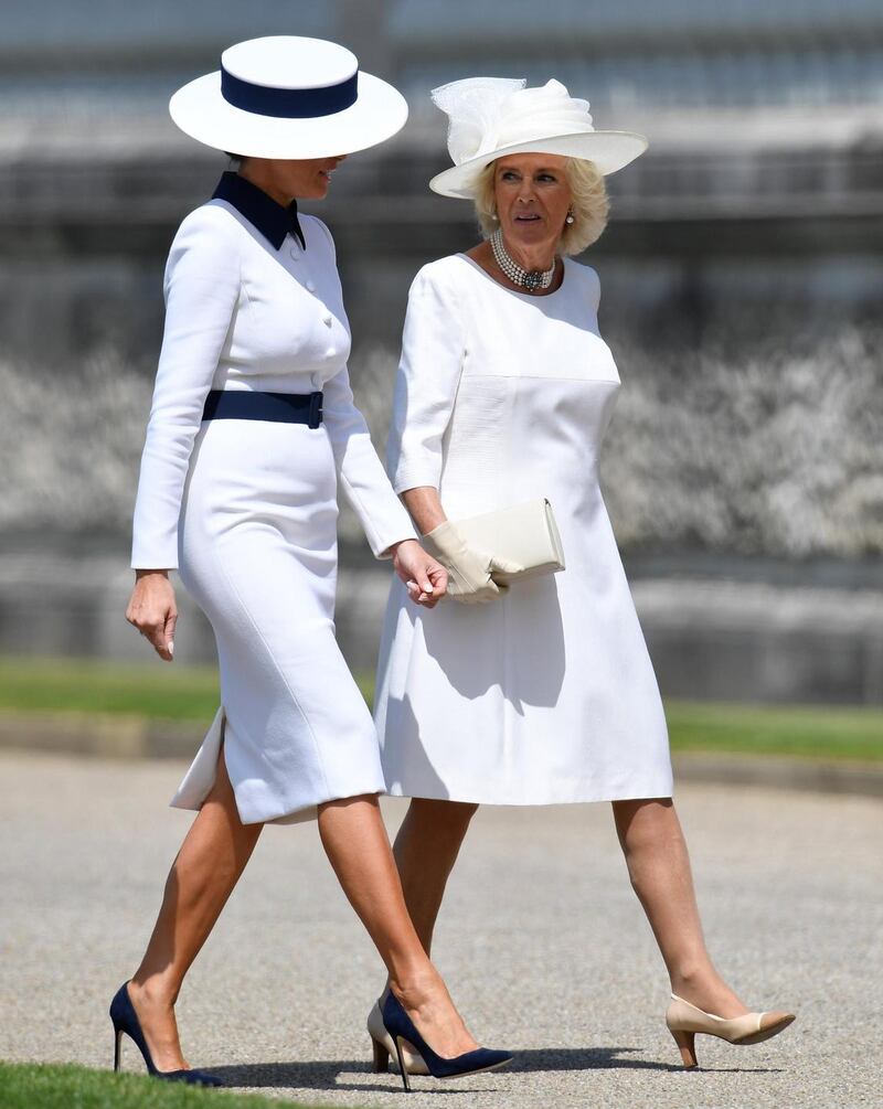 At Buckingham Palace with Camilla, duchess of Cornwall: Melania Trump’s tailored white pencil dress with navy trim and boater hat were similar to a look Diana, princess of Wales, wore in Japan in 1986. Photograph: Toby Melville/WPA Pool/Getty