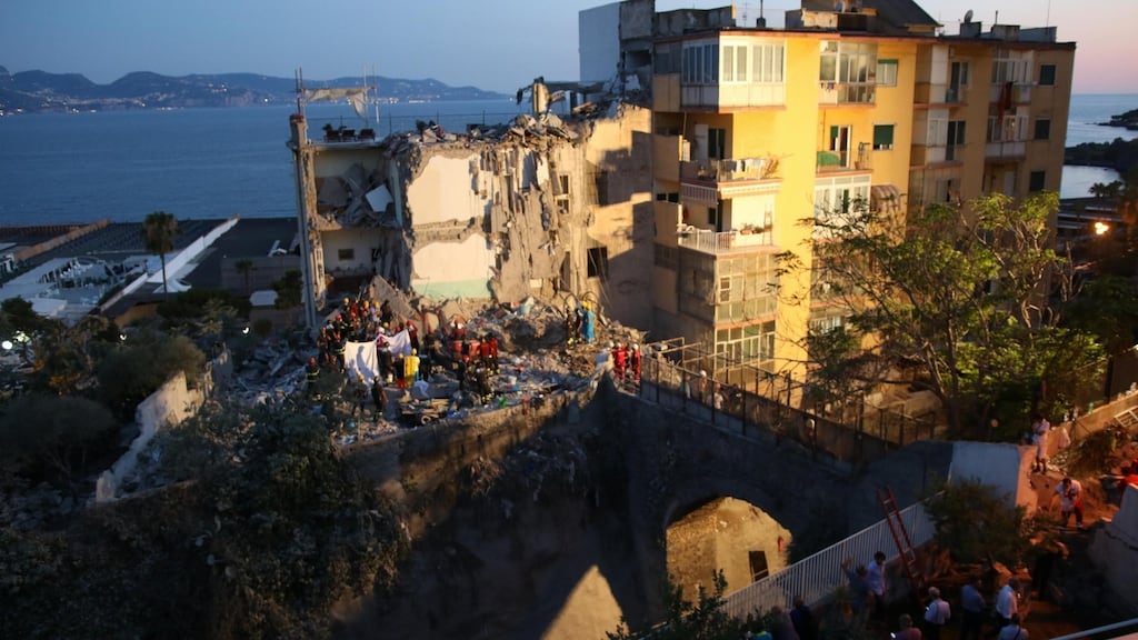 Rescuers work amid the rubble of a building that collapsed in Torre Annunziata, near Naples, southern Italy. Photograph: Ciro Fusco/ANSA via AP