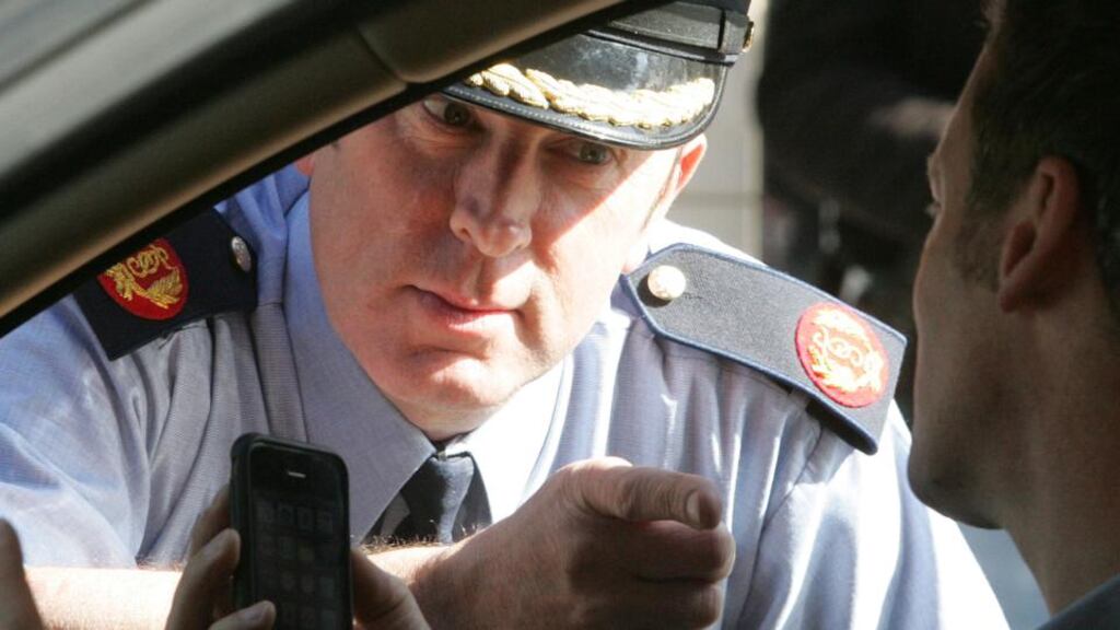 A file image showing Assistant Commissioner John Twomey with an actor at the launch of a road safety campaign. Photograph: The Irish Times