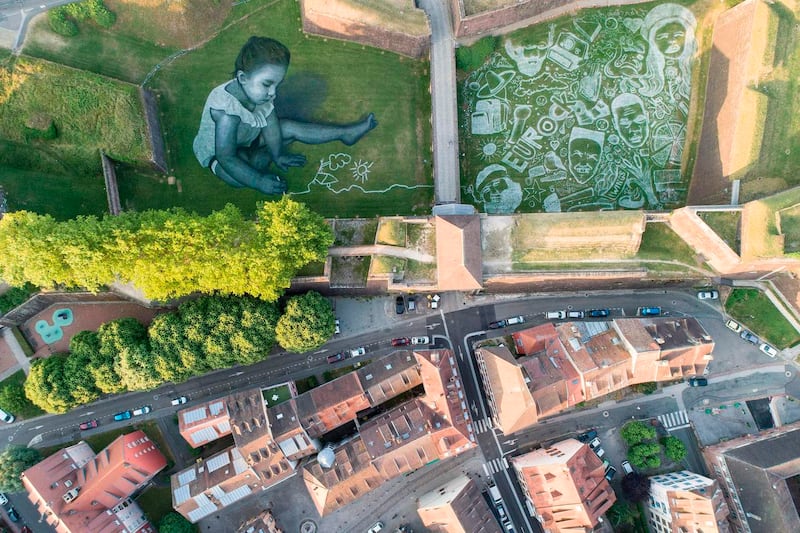 Saype: the festival mural dwarfed nearby houses. Photograph: Sebastien Bozon/AFP/Getty