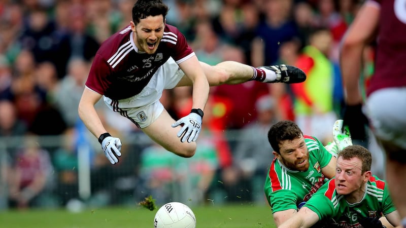 Ian Burke is fouled by Chris Barrett of Mayo to win a penalty. Photograph: Ryan Byrne/Inpho