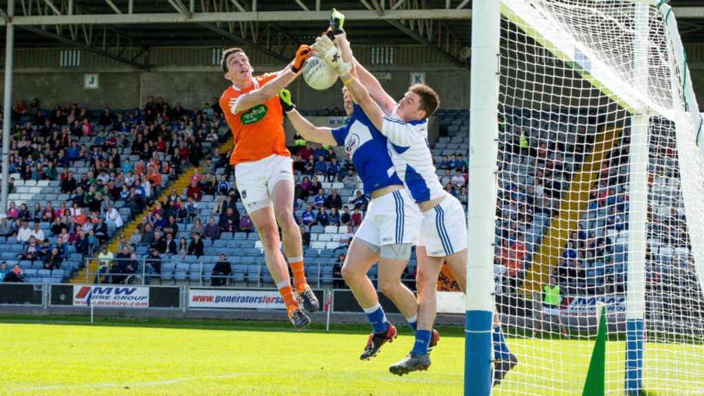 Armagh’s Rory Grugan scores a goal despite the attentions of Laois’ Mark Timmons and Graham Brody during the All-Ireland SFC Round 1A Qualifier replay at O’Moore Park in Portlaoise. photograph: Morgan Treacy/Inpho