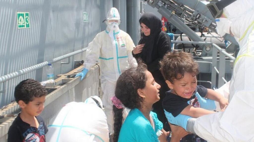 A migrant child cries as he is brought on board the ‘LE Niamh’ on Wednesday during the rescue of more than 550 people from a barge off the coast of Libya. Photograph: Defence Forces