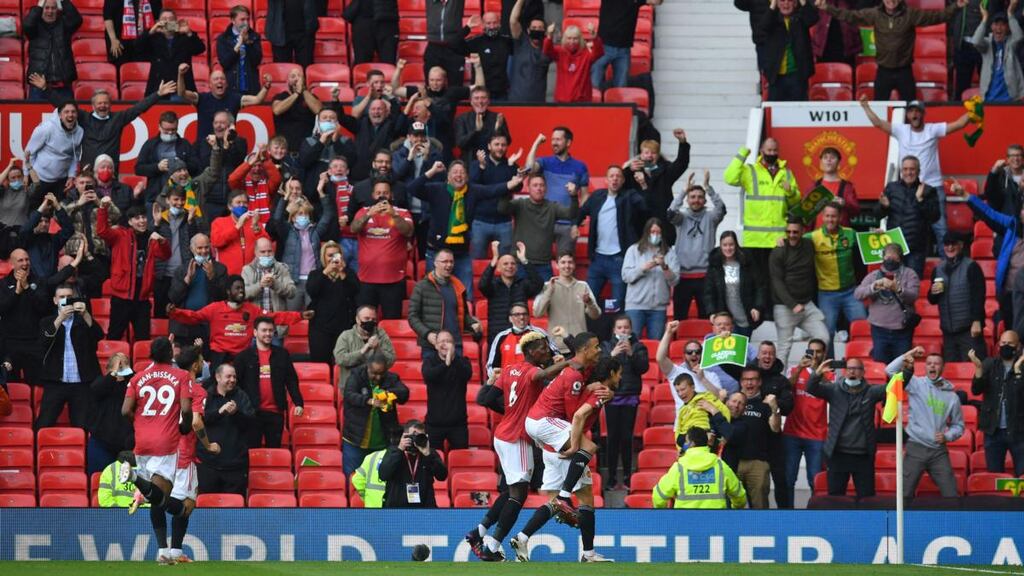 Manchester United and supporters celebrate Edinson Cavani’s opener at Old Trafford. Photograph: Paul Ellis/Getty/AFP