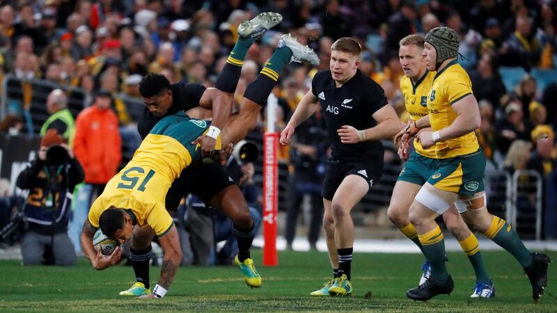 Australia’s Israel Folau is tackled by New Zealand’s Waisake Naholo during his side’s Rugby Championship defeat in Sydney. Photograph: David Gray/Reuters