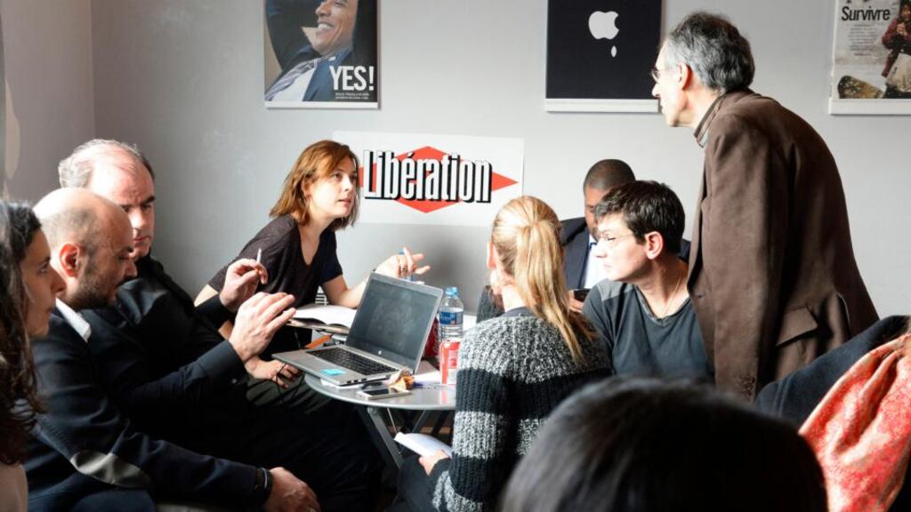 Employees from the satirical weekly Charlie Hebdo meet in the offices of the left-wing daily Libération in Paris. Two days after the attacks by terrorists on the weekly, the newspaper’s remaining staff members gathered to build the next issue while still in shock. Photograph: Bertrand Guay/Pool