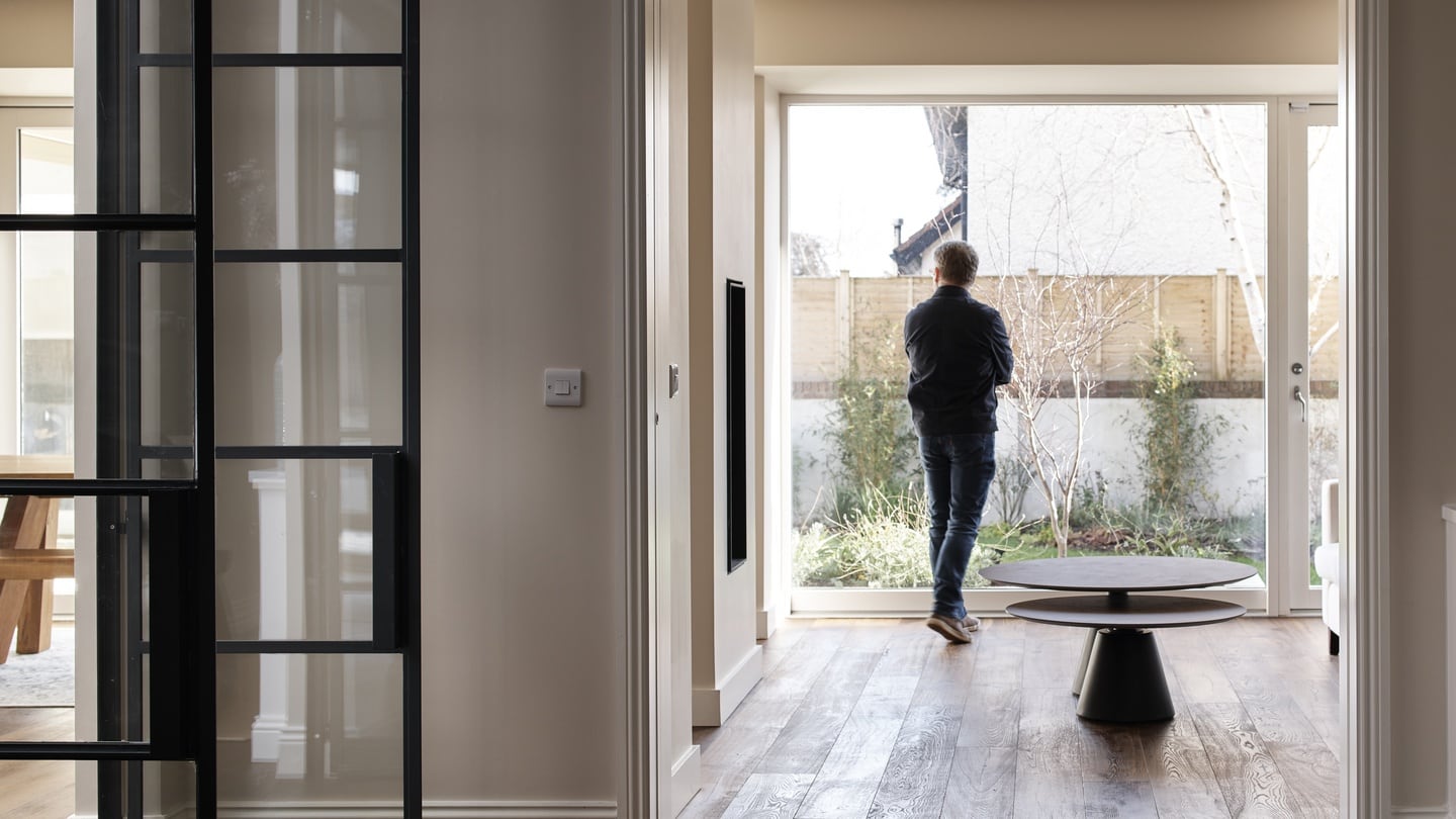 Steel-framed glass double doors lead into a spacious central space.