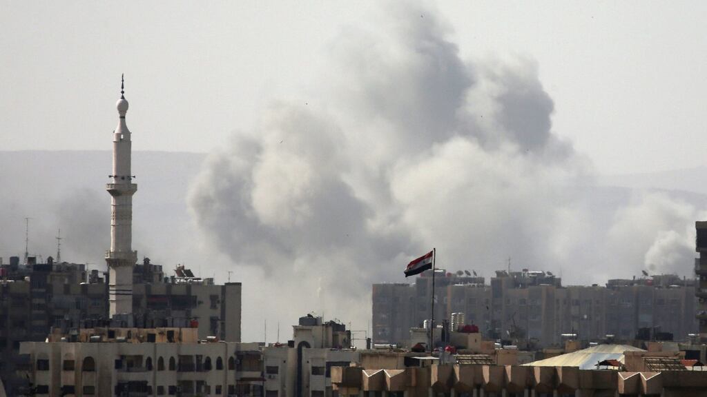 Smoke rises from the Yarmouk Palestinian refugee camp in Damascus on Friday. Photograph: Ali Hashisho/Reuters