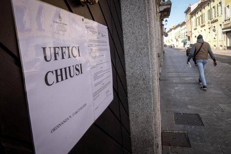 A person walks near a sign that reads ‘offices closed’ in the Codogno, Italy on February 22nd. Photograph: Matteo Corner/EPA