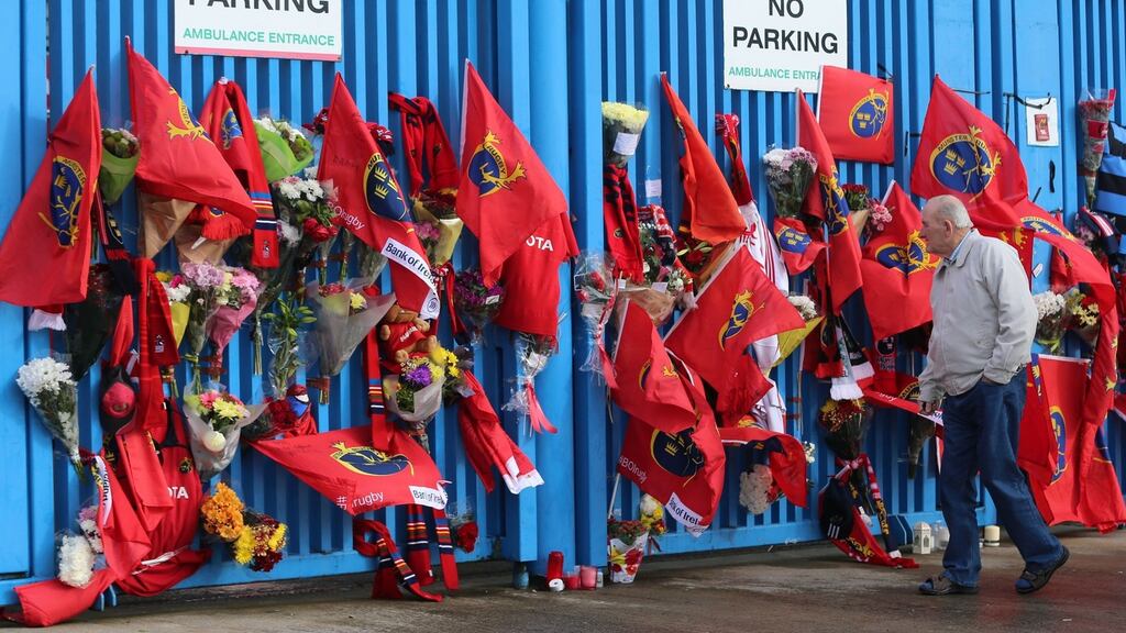 A Munster fan pays tribute to former Ireland and Munster star Anthony Foley outside Thomond Park in Limerick. Photo: Niall Carson/PA Wire