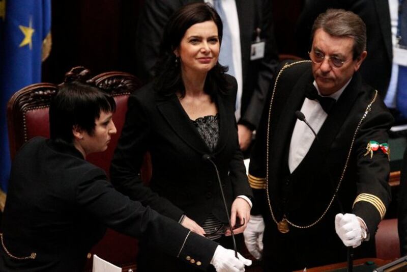 Staff members fix the microphone before Laura Boldrini from the centre-left gives a speech after the vote electing her as the new lower house president at the Chamber of Deputies in Rome. Photograph: Reuters