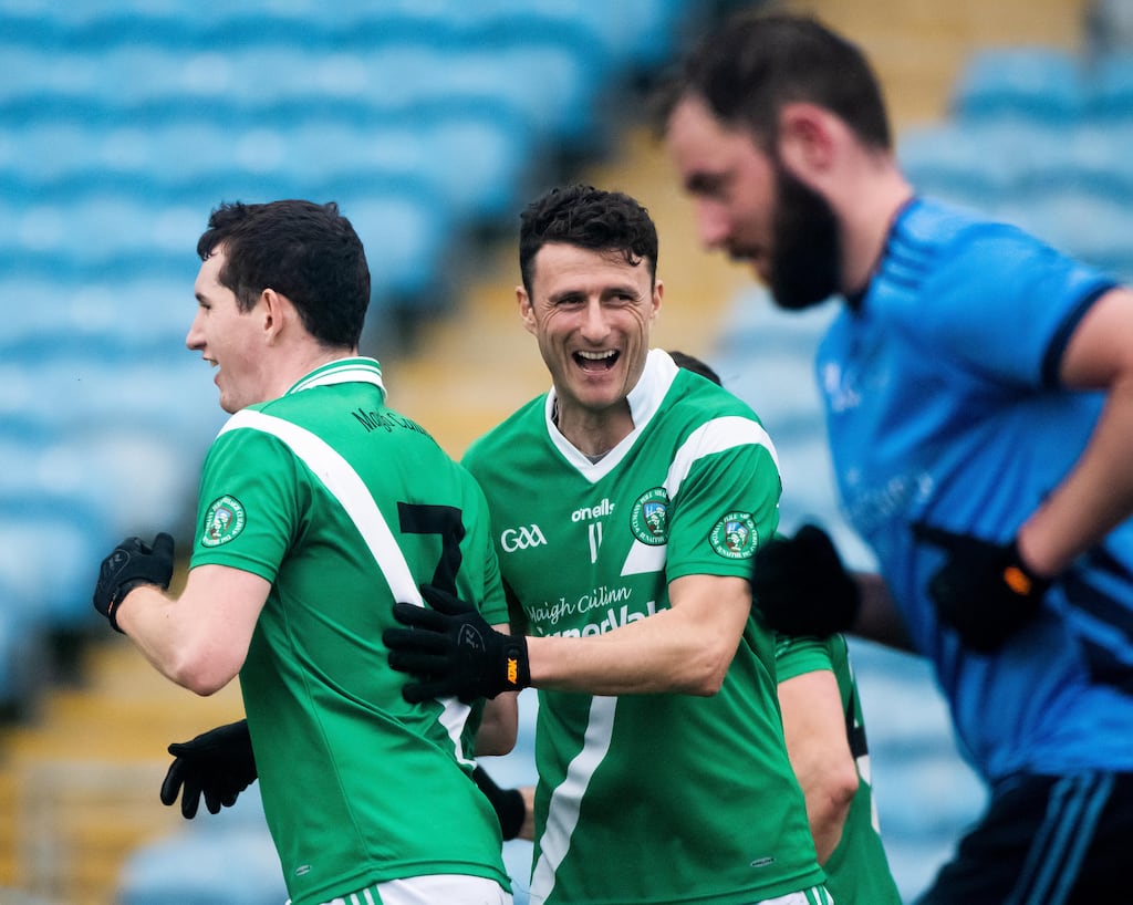 Moycullen's Conchuir Ó Bothain congratulates Aodán Ó Laithimh on his goal against Westport. Photograph: Evan Logan/Inpho