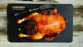 Roast fat duck with foie gras stuffing and lacquered duck heart skewers