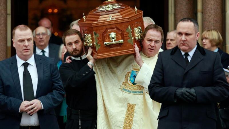 Friends and colleagues carry the coffin of Father Alec Reid after his funeral service at the Clonard Monastery in west Belfast today. Photograph: Cathal McNaughton/Reuters.