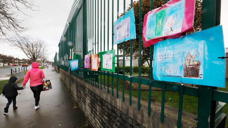 Children’s art hangs on the railing of St Canice’s Boys School in Finglas. The INTO says teachers are concerned about their own safety, the safety of their families, their pupils and their families. Photograph: Leon Farrell / RollingNews.ie