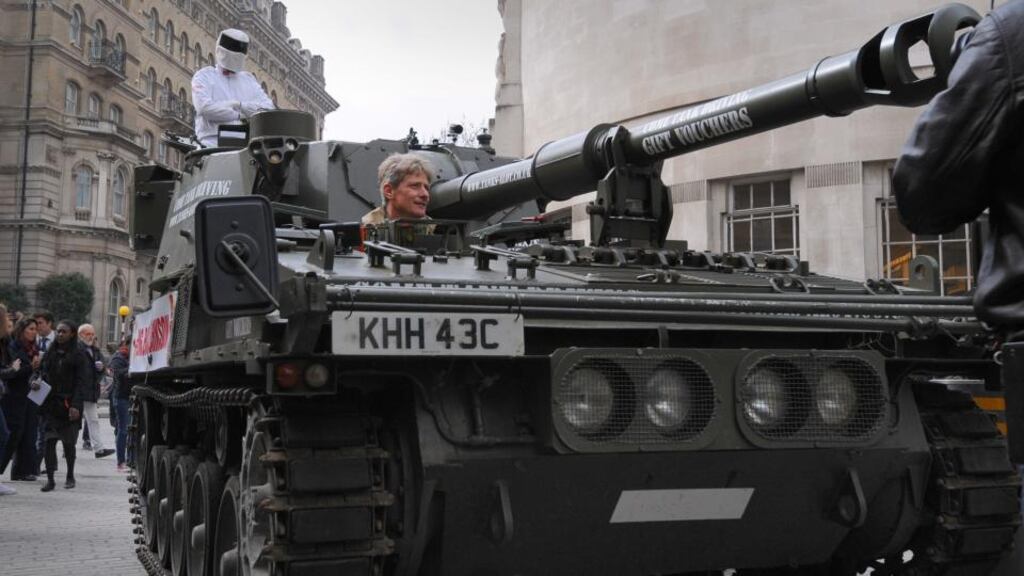 A man dressed as Top Gear’s ‘The Stig’ delivers a million signature petition by tank to the BBC at the New Broadcasting House, London. Photograph: PA