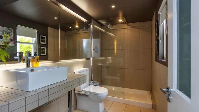 The existing bathroom was expanded by adding in the corridor beside it.