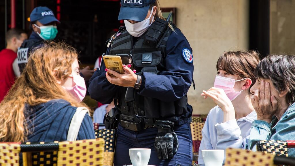 French police officers check customers’ health passes at a bar in Paris. Photograph: Christophe Petit Tesson/EPA