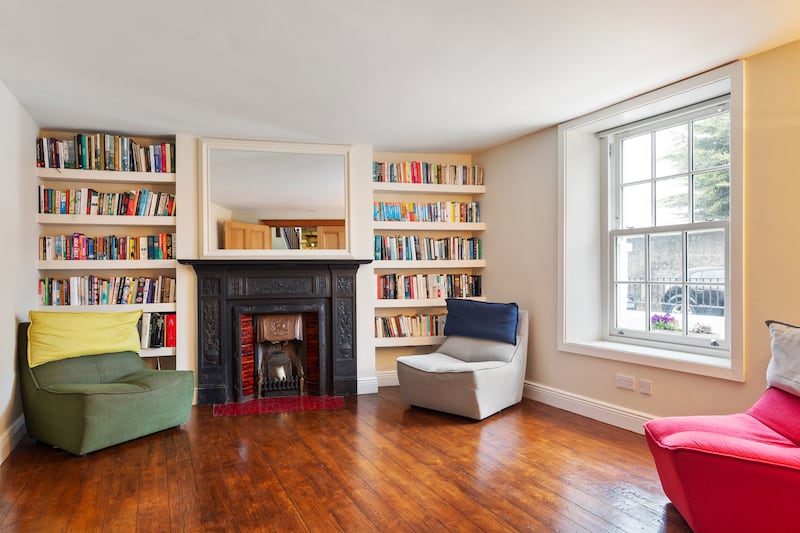Sittingroom with cast-iron fireplace. Photograph: Viv van der Holst